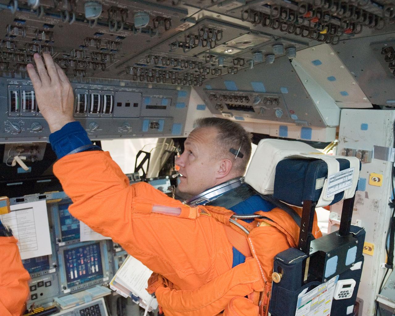 JSC2010-E-196898 (20 Dec. 2010) --- While seated at the pilot?s station, NASA astronaut Doug Hurley, STS-135 pilot, participates in a post insertion/de-orbit training session on the flight deck of the crew compartment trainer (CCT-2) in the Space Vehicle Mockup Facility at NASA's Johnson Space Center. Hurley is wearing a training version of his shuttle launch and entry suit. STS-135 is planned to be the final mission of the space shuttle program. Photo credit: NASA or National Aeronautics and Space Administration