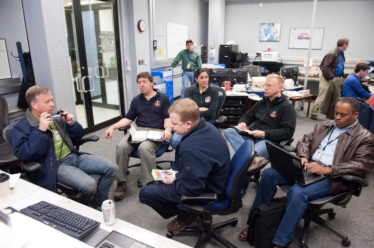 JSC2011-E-003036 (14 Jan. 2011) --- STS-133 crew members participate in a training session in the fixed-base shuttle mission simulator (SMS) and the Space Station Training Facility (SSTF) in the Jake Garn Simulation and Training Facility at NASA's Johnson Space Center. Pictured counter-clockwise from the left are NASA astronauts Steve Lindsey, commander; Eric Boe, pilot; Alvin Drew, Tim Kopra, Nicole Stott and Michael Barratt, all mission specialists. Photo credit: NASA or National Aeronautics and Space Administration