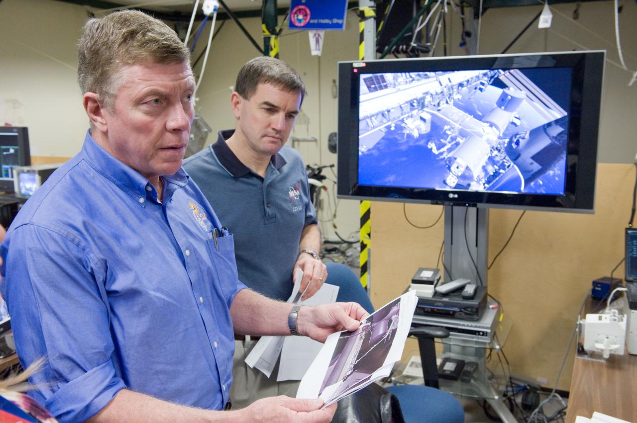 JSC2011-E-003204 (18 Jan. 2011) --- NASA astronauts Rex Walheim, STS-135 mission specialist; and Mike Fossum (foreground), Expedition 28 flight engineer and Expedition 29 commander; use the virtual reality lab in the Space Vehicle Mock-up Facility at NASA's Johnson Space Center to train for some of their duties aboard the space shuttle and space station. This type of computer interface, paired with virtual reality training hardware and software, helps to prepare crew members for dealing with space station elements. STS-135 is planned to be the final mission of the space shuttle program. Photo credit: NASA or National Aeronautics and Space Administration