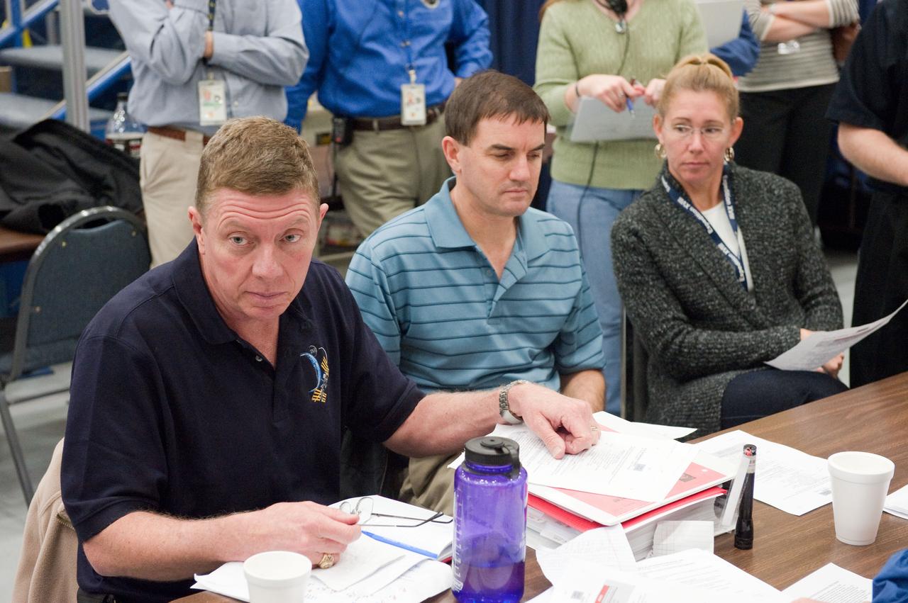 JSC2011-E-005861 (19 Jan. 2011) --- NASA astronauts Mike Fossum (left), Expedition 28 flight engineer and Expedition 29 commander; Rex Walheim and Sandy Magnus, both STS-135 mission specialists, participate in a joint emergency scenarios training session in the Space Vehicle Mock-up Facility at NASA's Johnson Space Center. STS-135 is planned to be the final mission of the space shuttle program. Photo credit: NASA or National Aeronautics and Space Administration