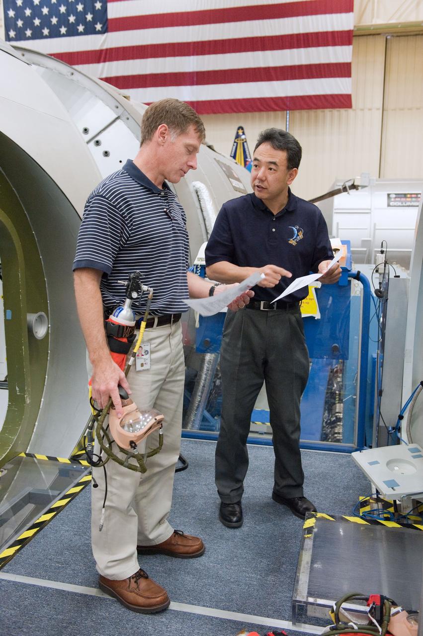 JSC2011-E-005869 (19 Jan. 2011) --- NASA astronaut Chris Ferguson (left), STS-135 commander; and Japan Aerospace Exploration Agency (JAXA) astronaut Satoshi Furukawa, Expedition 28/29 flight engineer, participate in a joint emergency scenarios training session in the Space Vehicle Mock-up Facility at NASA's Johnson Space Center. STS-135 is planned to be the final mission of the space shuttle program. Photo credit: NASA or National Aeronautics and Space Administration