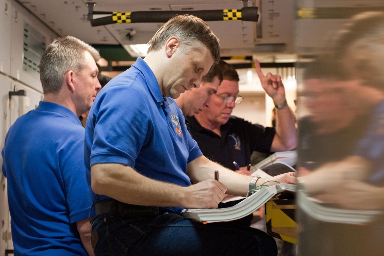 JSC2011-E-005875 (19 Jan. 2011) --- Russian cosmonauts Andrey Borisenko (foreground), Expedition 27 flight engineer and Expedition 28 commander; Alexander Samokutyaev (left), Expedition 27/28 flight engineer; and Sergei Volkov, Expedition 28/29 flight engineer; along with NASA astronaut Mike Fossum (right background), Expedition 28 flight engineer and Expedition 29 commander, participate in an emergency scenarios training session in the Space Vehicle Mock-up Facility at NASA's Johnson Space Center. Photo credit: NASA or National Aeronautics and Space Administration