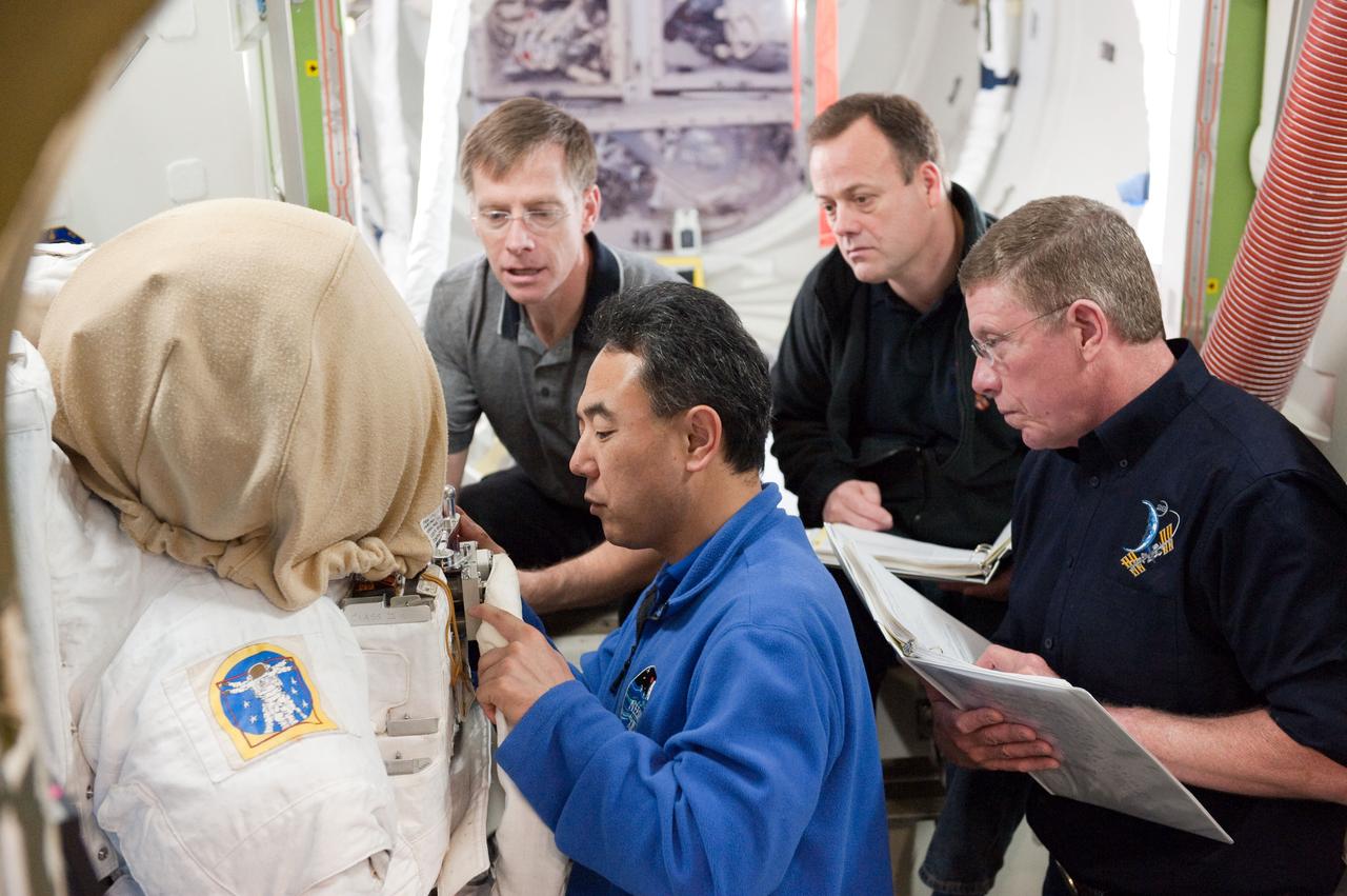 PHOTO DATE:  01-25-11 LOCATION: Bldg 9NW,  ISS Mockups SUBJECT:  Expedition 28 crew member and JAXA astronaut Satoshi Furukawa during ISS EVA P/P 33105 training with STS-135 crew members PHOTOGRAPHER:  James Blair 