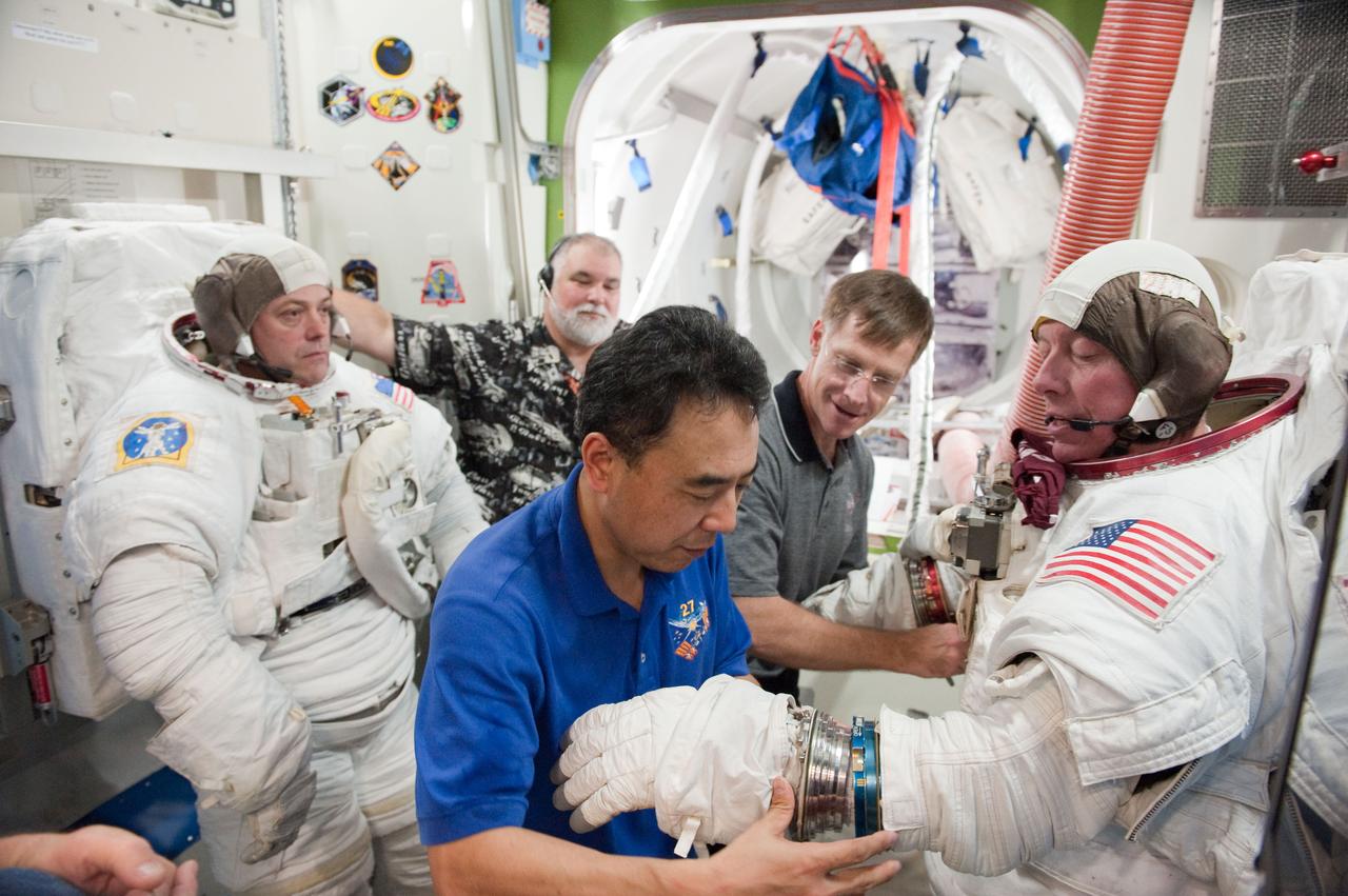 PHOTO DATE:  01-25-11 LOCATION: Bldg 9NW,  ISS Mockups SUBJECT:  Expedition 28 crew member and JAXA astronaut Satoshi Furukawa during ISS EVA P/P 33105 training with STS-135 crew members PHOTOGRAPHER:  James Blair 