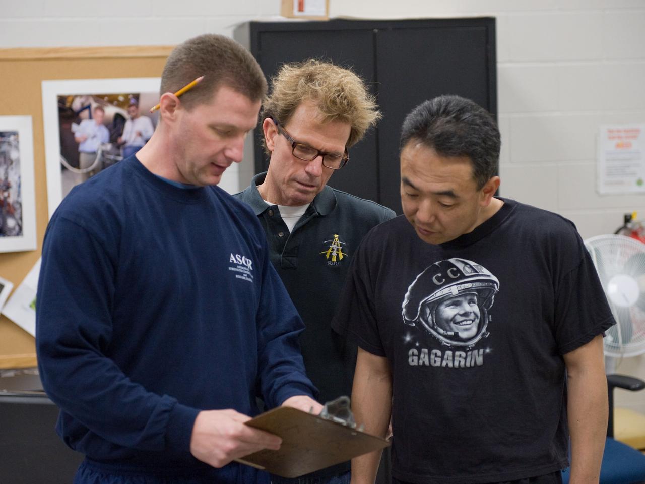 PHOTO DATE:  02-03-11 LOCATION: Bldg 26, 104 SUBJECT: Photograph JAXA astronaut and Expedition 28 crew member Satoshi Furukawa during ARED PT training. Instructors are Robert Tweedy (glasses) and BruceNieschwitz PHOTOGRAPHER:  James Blair