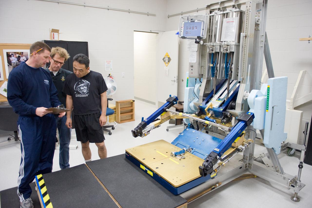 PHOTO DATE:  02-03-11 LOCATION: Bldg 26, 104 SUBJECT: Photograph JAXA astronaut and Expedition 28 crew member Satoshi Furukawa during ARED PT training. Instructors are Robert Tweedy (glasses) and BruceNieschwitz PHOTOGRAPHER:  James Blair