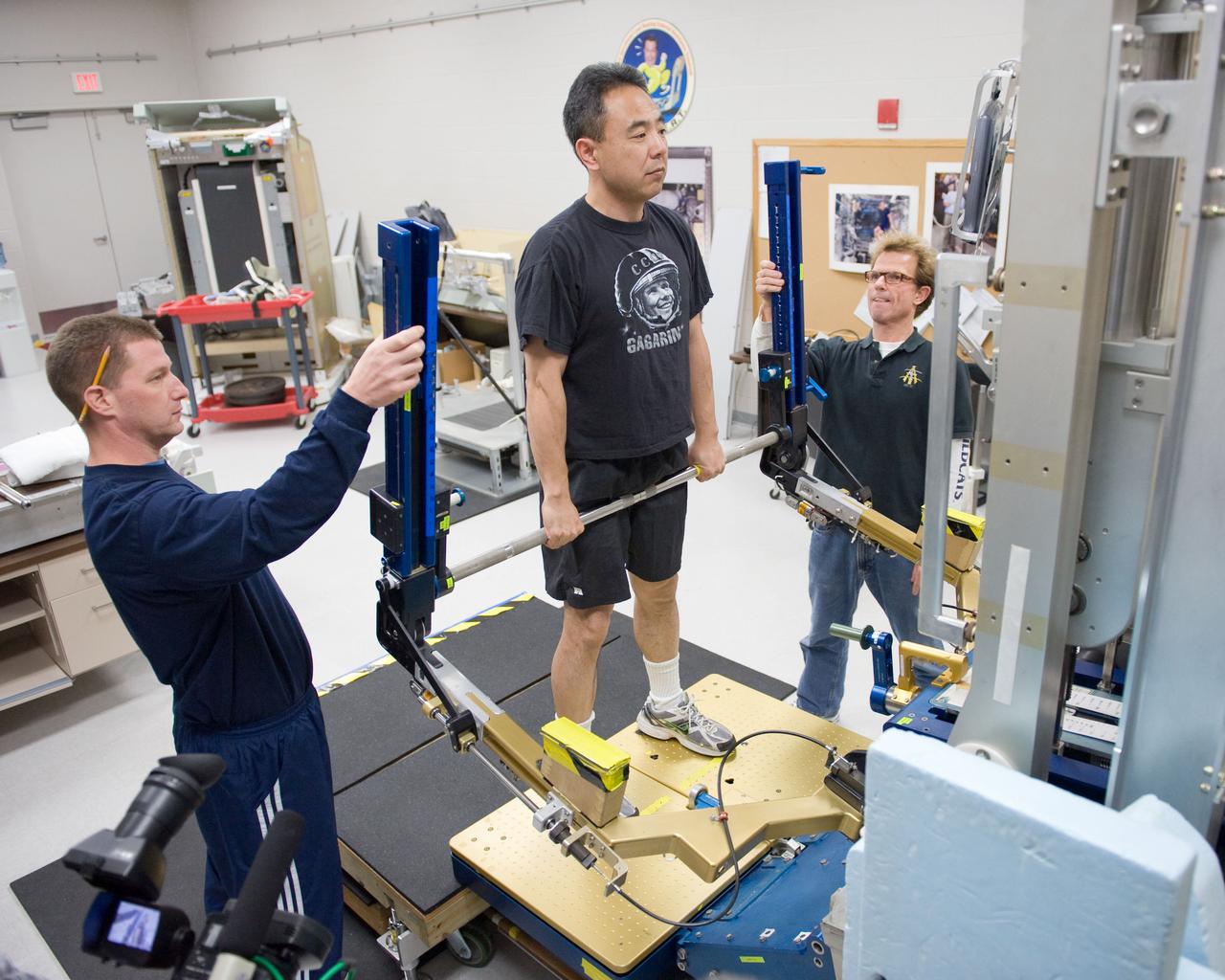 PHOTO DATE:  02-03-11 LOCATION: Bldg 26, 104 SUBJECT: Photograph JAXA astronaut and Expedition 28 crew member Satoshi Furukawa during ARED PT training. Instructors are Robert Tweedy (glasses) and BruceNieschwitz PHOTOGRAPHER:  James Blair