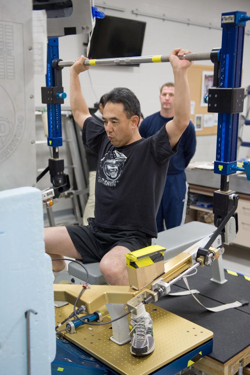 PHOTO DATE:  02-03-11 LOCATION: Bldg 26, 104 SUBJECT: Photograph JAXA astronaut and Expedition 28 crew member Satoshi Furukawa during ARED PT training. Instructors are Robert Tweedy (glasses) and BruceNieschwitz PHOTOGRAPHER:  James Blair