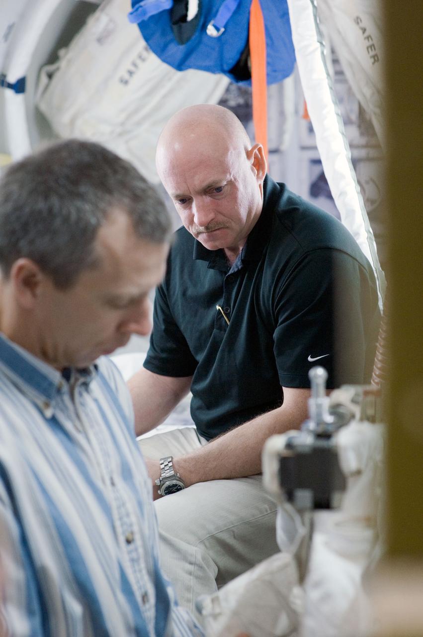 JSC2011-E-015844 (9 Feb. 2011) --- NASA astronauts Mark Kelly (background), STS-134 commander; and Andrew Feustel, mission specialist, participate in an EVA simulation session in a space station mock-up in the Space Vehicle Mock-up Facility at NASA's Johnson Space Center. Photo credit: NASA or National Aeronautics and Space Administration