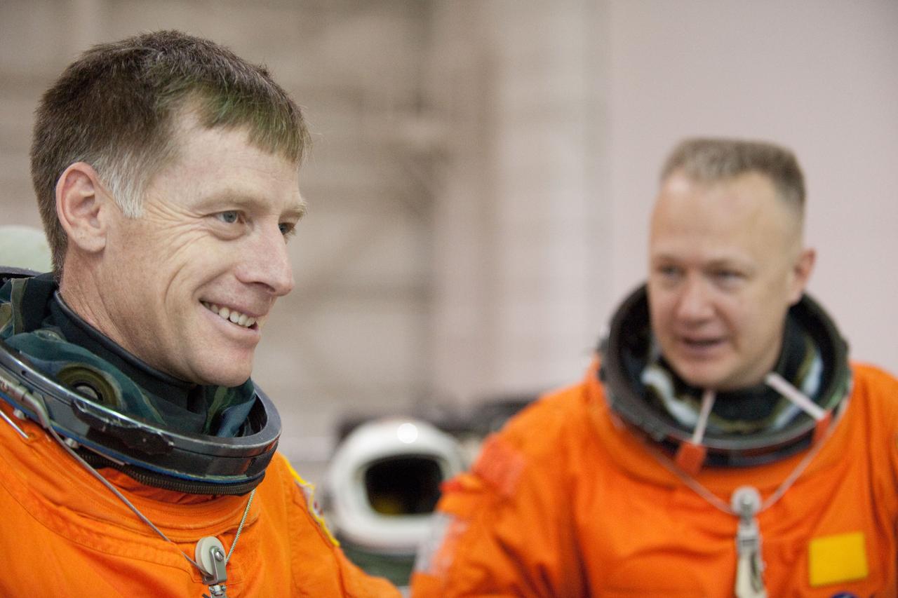 JSC2011-E-016231 (9 Feb. 2011) --- NASA astronauts Chris Ferguson (left), STS-135 commander; and Doug Hurley, pilot, attired in training versions of their shuttle launch and entry suits, are pictured during a water survival training session in the Neutral Buoyancy Laboratory (NBL) near NASA's Johnson Space Center. STS-135 is planned to be the final mission of the space shuttle program. Photo credit: NASA or National Aeronautics and Space Administration