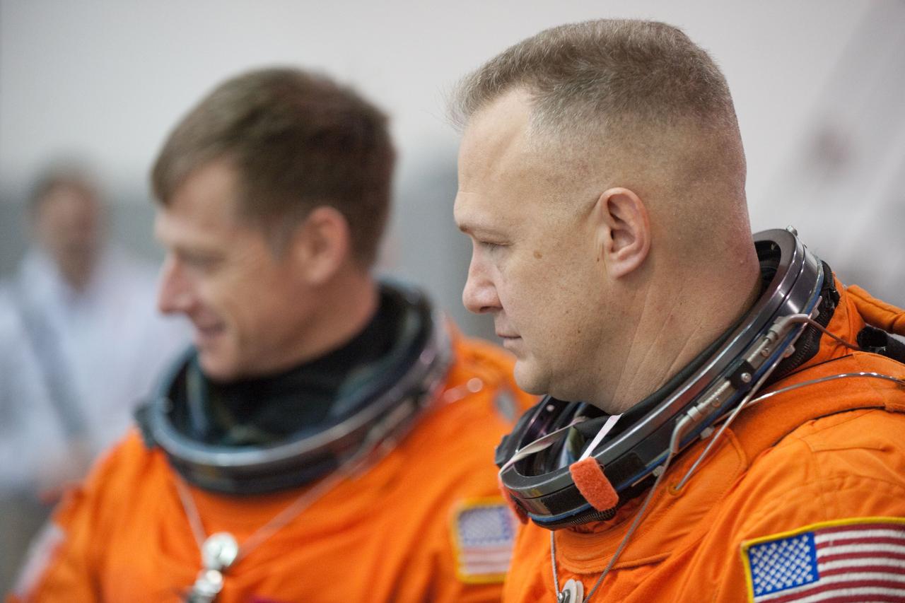 JSC2011-E-016249 (9 Feb. 2011) --- NASA astronauts Doug Hurley (foreground), STS-135 pilot; and Chris Ferguson, commander, attired in training versions of their shuttle launch and entry suits, are pictured during a water survival training session in the Neutral Buoyancy Laboratory (NBL) near NASA's Johnson Space Center. STS-135 is planned to be the final mission of the space shuttle program. Photo credit: NASA or National Aeronautics and Space Administration