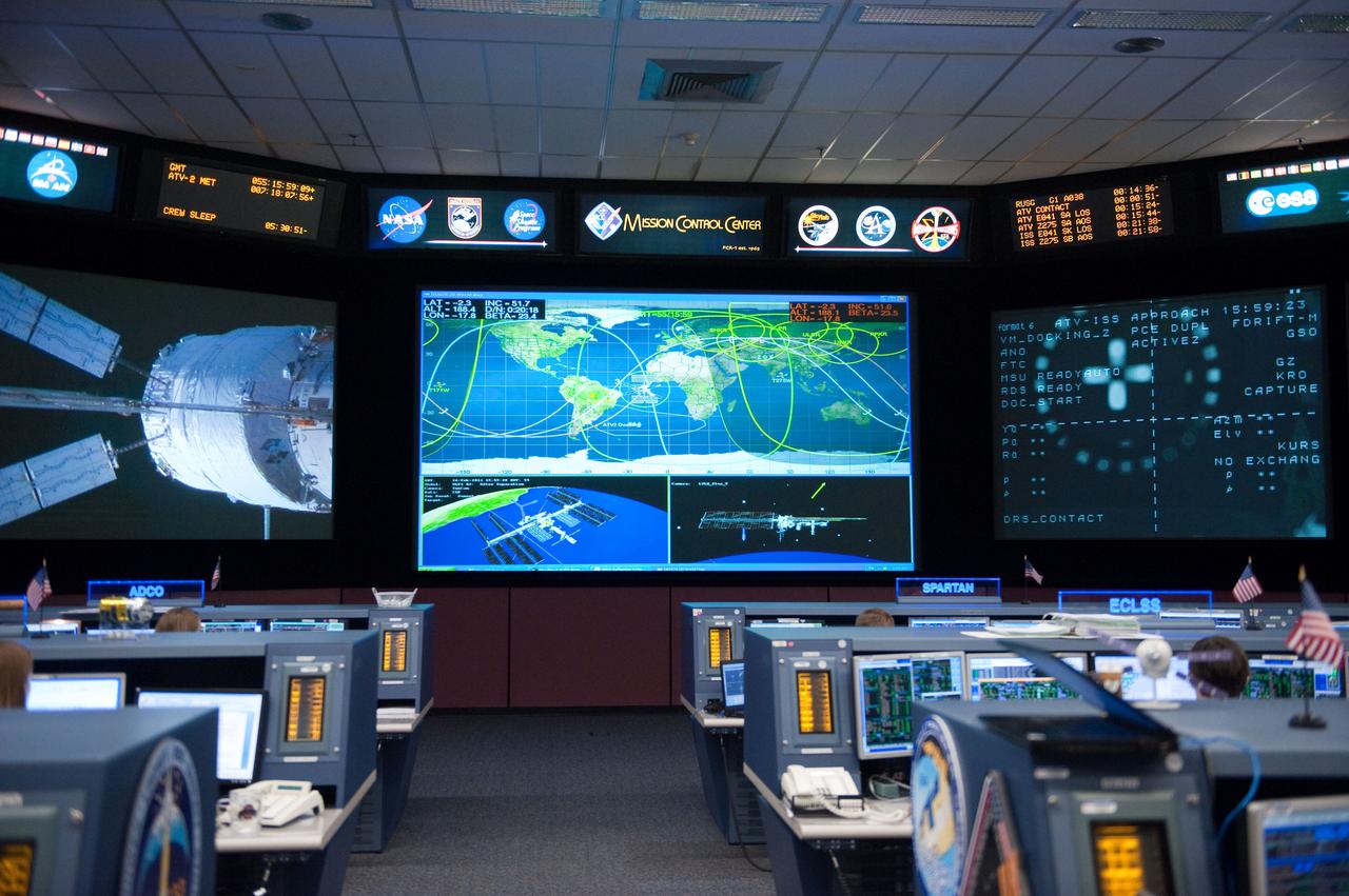 ISS Orbit 2 flight controllers on console with Flight Director Bob Dempsey during the ESA ATV docking to space station.  Photo Date: February 24, 2011.  Location: Building 30M, FCR-1.  Photographer: Robert Markowitz.