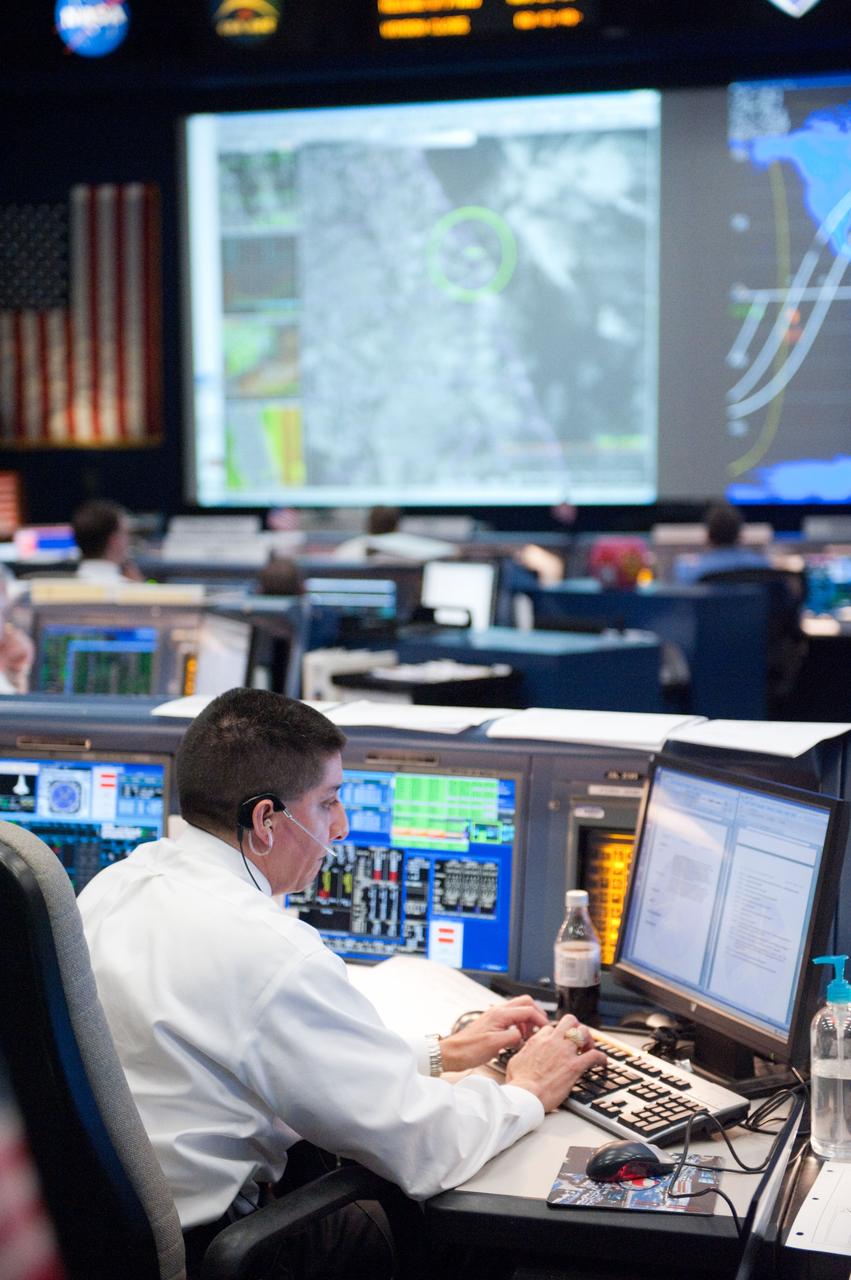 STS-133 flight controllers on console during the launch of Discovery with Flight Director Richard Jones.  Photo Date: February 24, 2011.  Location: Building 30 south - WFCR.  Photographer: Robert Markowitz.