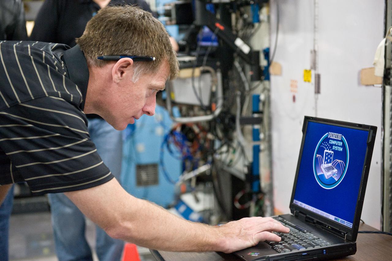 JSC2011-E-021704 (25 Feb. 2011) --- NASA astronaut Chris Ferguson, STS-135 commander, uses a computer during a training session in a space station mock-up in the Space Vehicle Mock-up Facility at NASA's Johnson Space Center. Photo credit: NASA or National Aeronautics and Space Administration