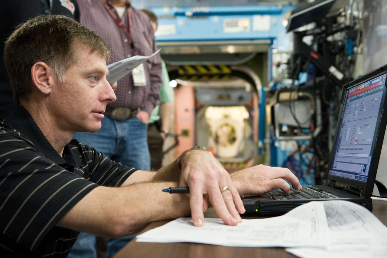 JSC2011-E-021708 (25 Feb. 2011) --- NASA astronaut Chris Ferguson, STS-135 commander, uses a computer during a training session in a space station mock-up in the Space Vehicle Mock-up Facility at NASA's Johnson Space Center. Photo credit: NASA or National Aeronautics and Space Administration