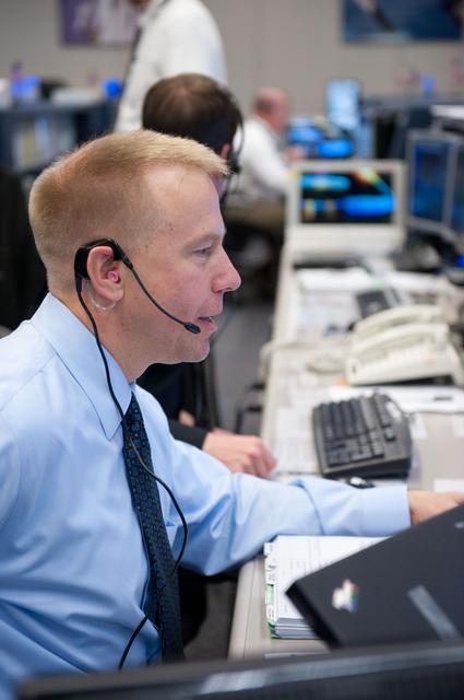NASA image: STS-133/ULF5 Flight Controllers on Console - EVA 1 with Orbit 1
