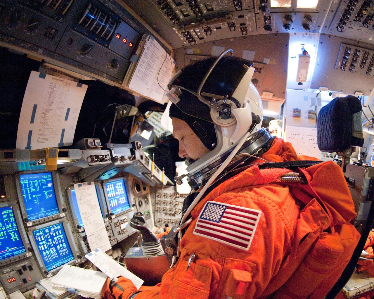JSC2011-E-023123 (2 March 2011) --- NASA astronaut Doug Hurley, STS-135 pilot, attired in a training version of his shuttle launch and entry suit, participates in a training session in the fixed-base shuttle mission simulator (SMS) in the Jake Garn Simulation and Training Facility at NASA's Johnson Space Center. Photo credit: NASA or National Aeronautics and Space Administration