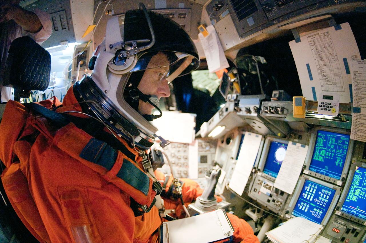 JSC2011-E-023124 (2 March 2011) --- NASA astronaut Chris Ferguson, STS-135 commander, attired in a training version of his shuttle launch and entry suit, participates in a training session in the fixed-base shuttle mission simulator (SMS) in the Jake Garn Simulation and Training Facility at NASA's Johnson Space Center. Photo credit: NASA or National Aeronautics and Space Administration