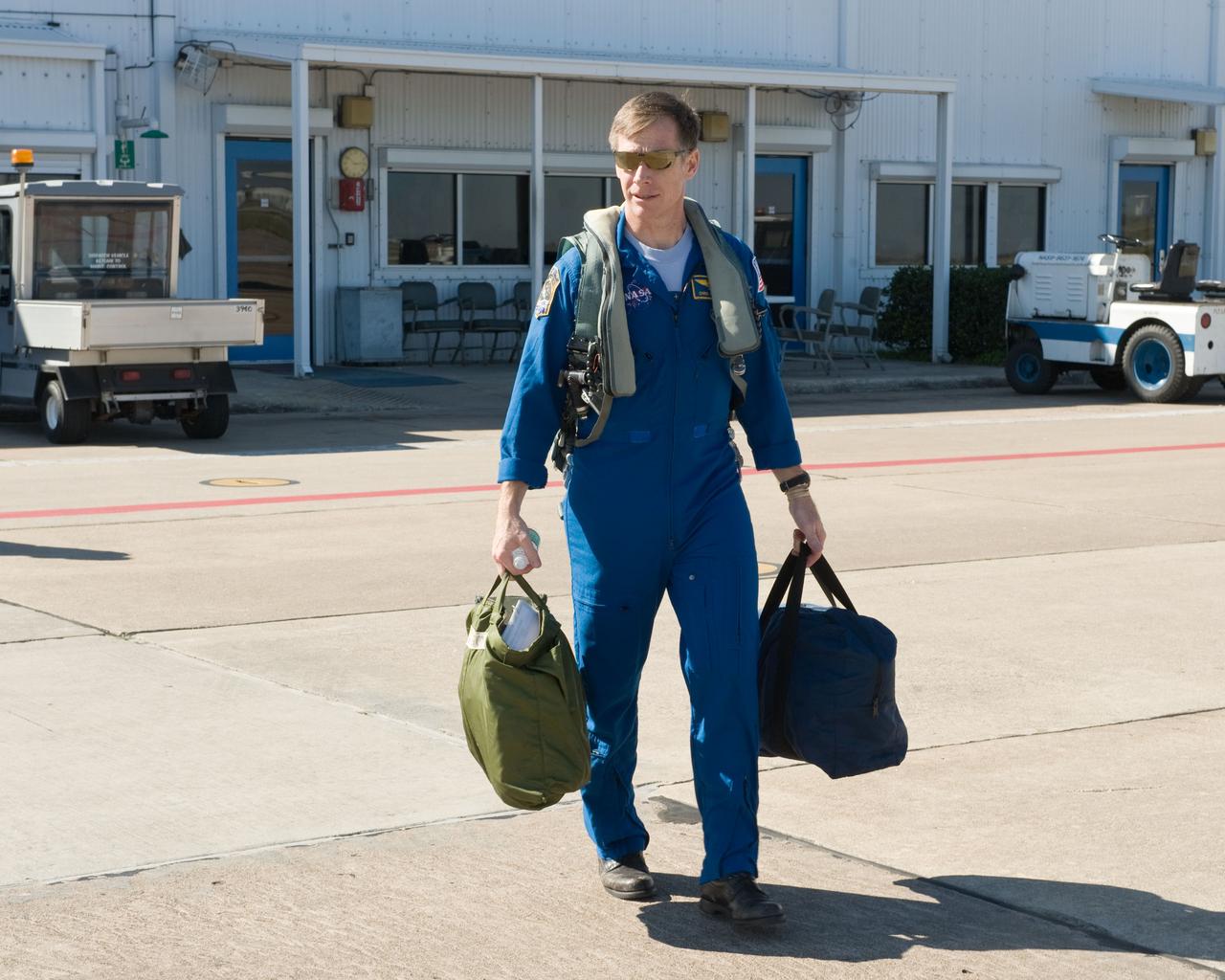 JSC2011-E-024188 (1 March 2011) --- NASA astronaut Chris Ferguson, STS-135 commander, walks to the nearby flight line of NASA T-38 trainer jets at Ellington Field near NASA's Johnson Space Center prior to a flight. Photo credit: NASA or National Aeronautics and Space Administration