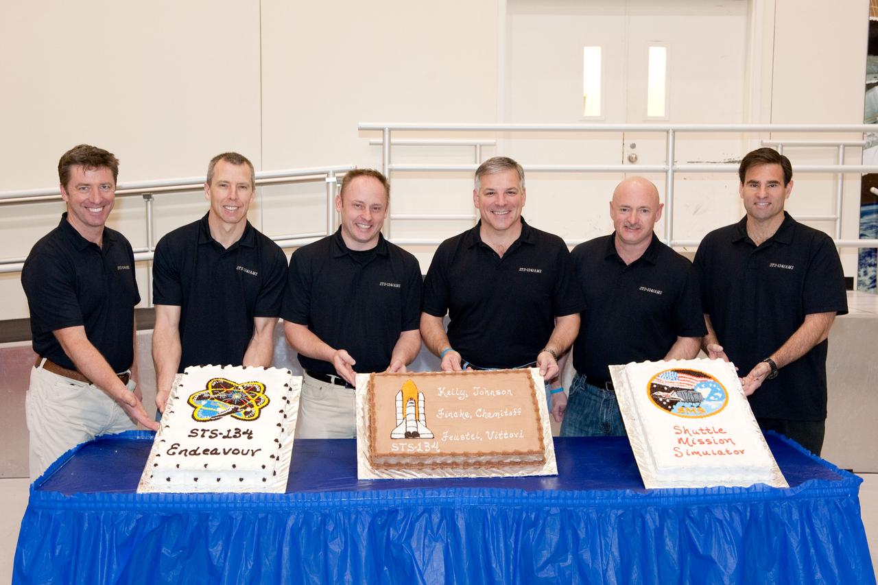 JSC2011-E-024812 (8 March 2011) --- STS-134 crew members pose for a photo during a cake-cutting ceremony in the Jake Garn Simulation and Training Facility at NASA's Johnson Space Center. Pictured from the left are European Space Agency astronaut Roberto Vittori, NASA astronauts Andrew Feustel, Michael Fincke, all mission specialists; Greg H. Johnson, pilot; Mark Kelly, commander; and Greg Chamitoff, mission specialist. Photo credit: NASA or National Aeronautics and Space Administration