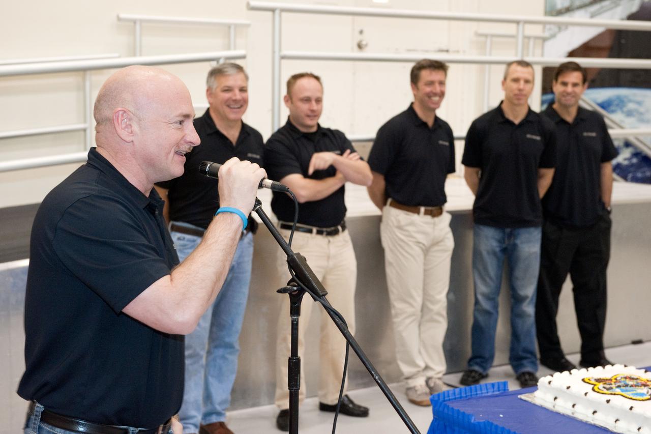 JSC2011-E-024816 (8 March 2011) --- NASA astronaut Mark Kelly, STS-134 commander, speaks to a crowd during a cake-cutting ceremony in the Jake Garn Simulation and Training Facility at NASA's Johnson Space Center. Also pictured in the background (from the left) are NASA astronaut Greg H. Johnson, pilot; NASA astronaut Michael Fincke, European Space Agency astronaut Roberto Vittori, NASA astronauts Andrew Feustel and Greg Chamitoff, all mission specialists. Photo credit: NASA or National Aeronautics and Space Administration