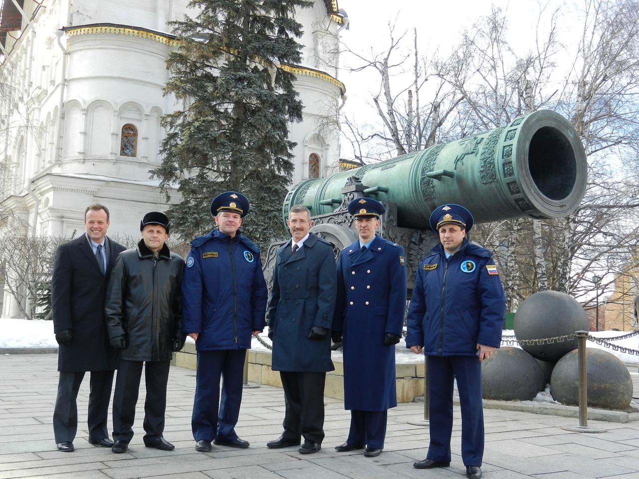 After laying flowers at the Kremlin Wall in Moscow March 11, 2011 as part of their ceremonial activities, the Expedition 27 prime and backup crew members pose for photographers in front of the Tsar Cannon at the Kremlin. From left to right are NASA astronaut Ron Garan, prime Expedition 27 flight engineer; Russian cosmonauts Andrey Borisenko and Alexander Samokutyaev; and their backups -- NASA astronaut Daniel Burbank, and Russian cosmonauts Anatoly Ivanishin and Anton Shklaperov. The three prime crew members will launch March 30 (Kazakhstan time) in their Soyuz TMA-21 spacecraft to the International Space Station. Photo credit: NASA/Stephanie Stoll