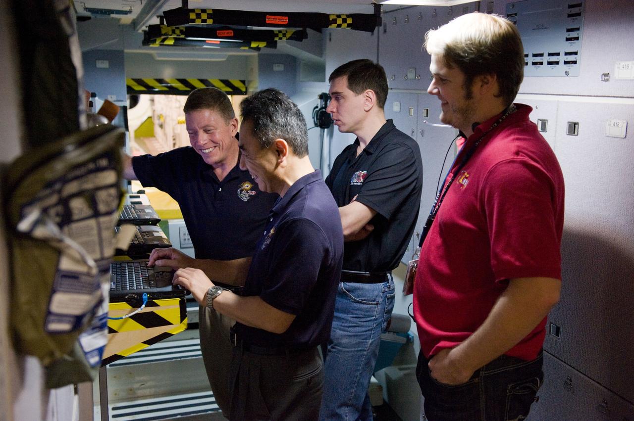 DATE: 3-15-11 LOCATION: Building 9 - ISS Mockup SUBJECT: Expedition 28/29 crew members during Docking Timeline Training. PHOTOGRAPHER: Lauren Harnett