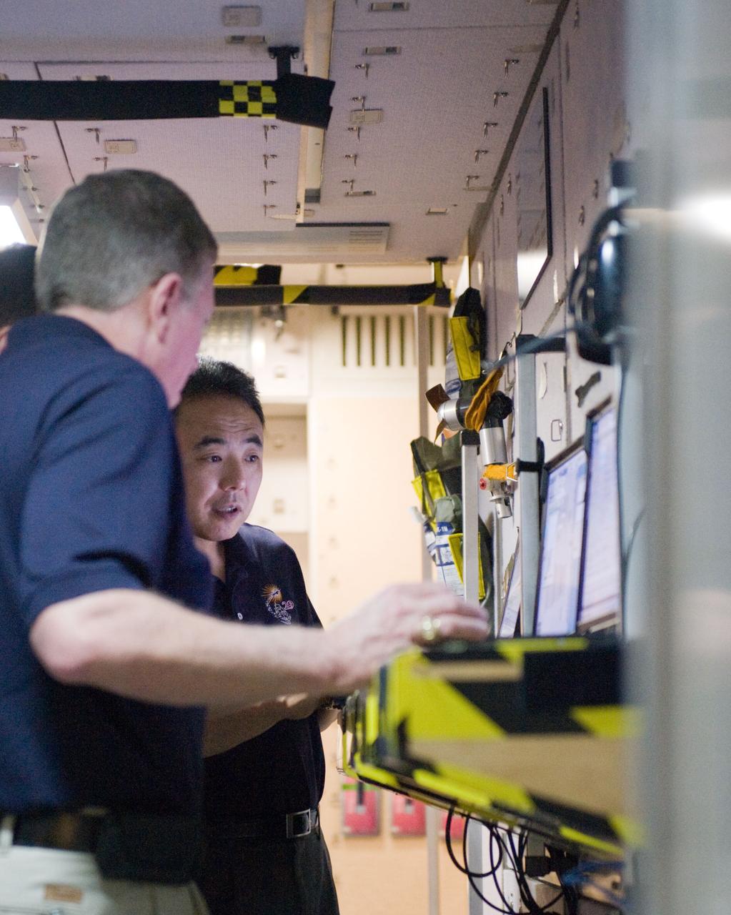 DATE: 3-15-11 LOCATION: Building 9 - ISS Mockup SUBJECT: Expedition 28/29 crew members during Docking Timeline Training. PHOTOGRAPHER: Lauren Harnett