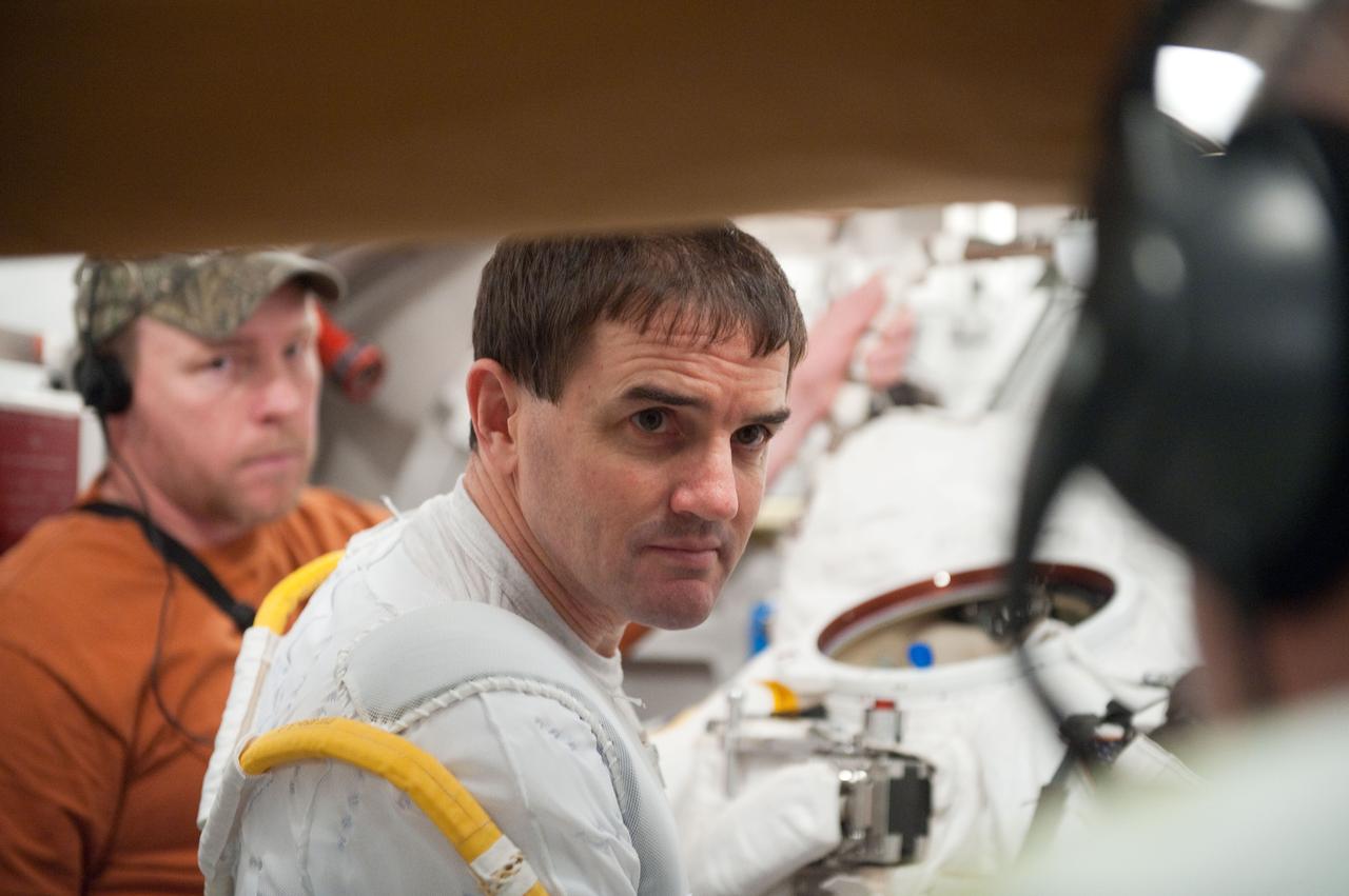 JSC2011-E-026866 (11 March 2011) --- NASA astronaut Rex Walheim, STS-135 mission specialist, participates in an Extravehicular Mobility Unit (EMU) spacesuit fit check in the Space Station Airlock Test Article (SSATA) in the Crew Systems Laboratory at NASA's Johnson Space Center. Photo credit: NASA or National Aeronautics and Space Administration