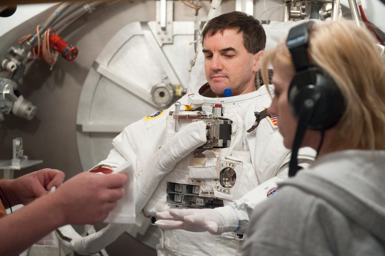 JSC2011-E-026868 (11 March 2011) --- NASA astronaut Rex Walheim, STS-135 mission specialist, participates in an Extravehicular Mobility Unit (EMU) spacesuit fit check in the Space Station Airlock Test Article (SSATA) in the Crew Systems Laboratory at NASA's Johnson Space Center. Photo credit: NASA or National Aeronautics and Space Administration