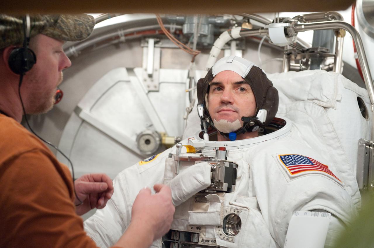 JSC2011-E-026872 (11 March 2011) --- NASA astronaut Rex Walheim, STS-135 mission specialist, participates in an Extravehicular Mobility Unit (EMU) spacesuit fit check in the Space Station Airlock Test Article (SSATA) in the Crew Systems Laboratory at NASA's Johnson Space Center. Photo credit: NASA or National Aeronautics and Space Administration