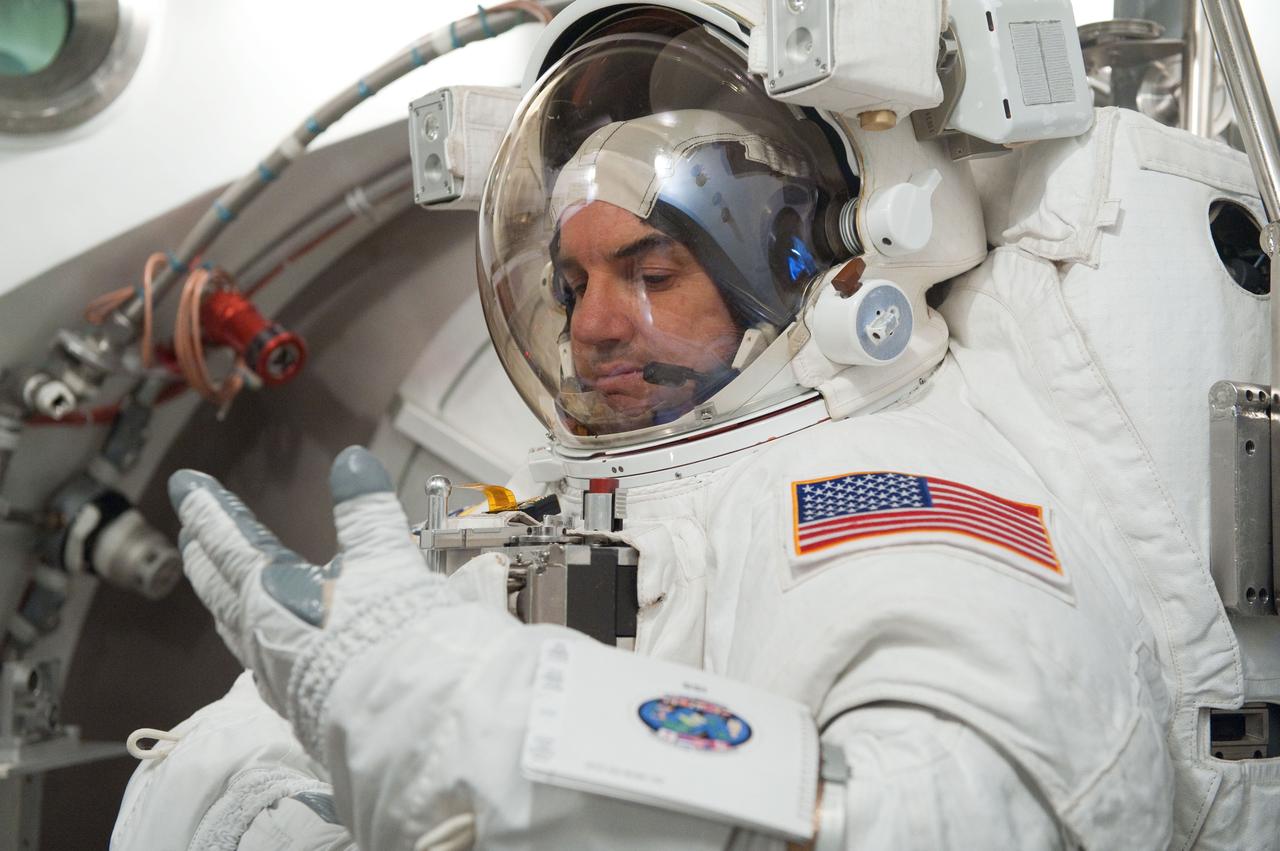 JSC2011-E-026878 (11 March 2011) --- NASA astronaut Rex Walheim, STS-135 mission specialist, participates in an Extravehicular Mobility Unit (EMU) spacesuit fit check in the Space Station Airlock Test Article (SSATA) in the Crew Systems Laboratory at NASA's Johnson Space Center. Photo credit: NASA or National Aeronautics and Space Administration