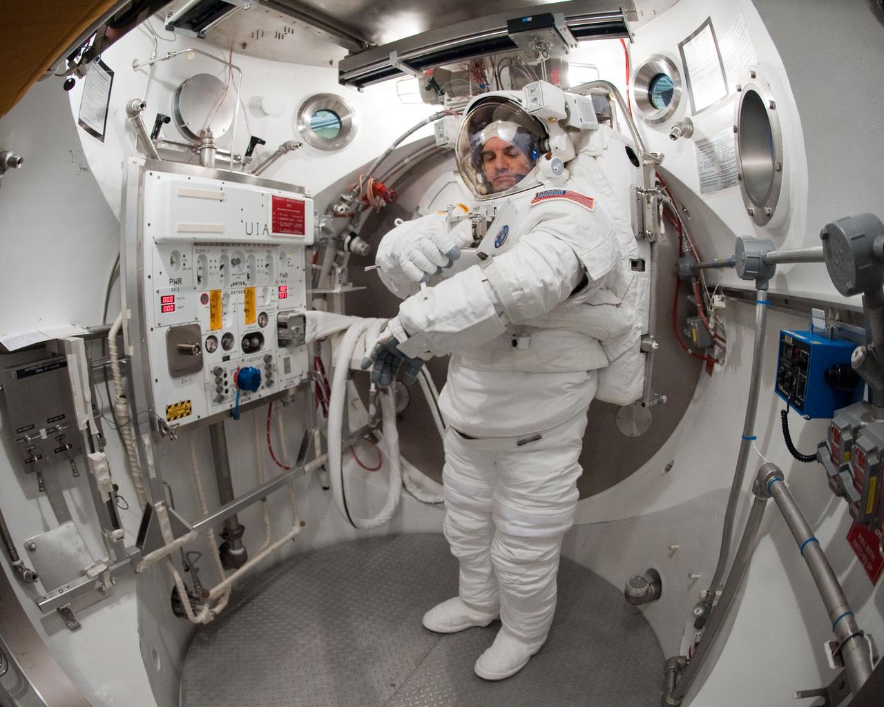 JSC2011-E-026879 (11 March 2011) --- NASA astronaut Rex Walheim, STS-135 mission specialist, participates in an Extravehicular Mobility Unit (EMU) spacesuit fit check in the Space Station Airlock Test Article (SSATA) in the Crew Systems Laboratory at NASA's Johnson Space Center. Photo credit: NASA or National Aeronautics and Space Administration