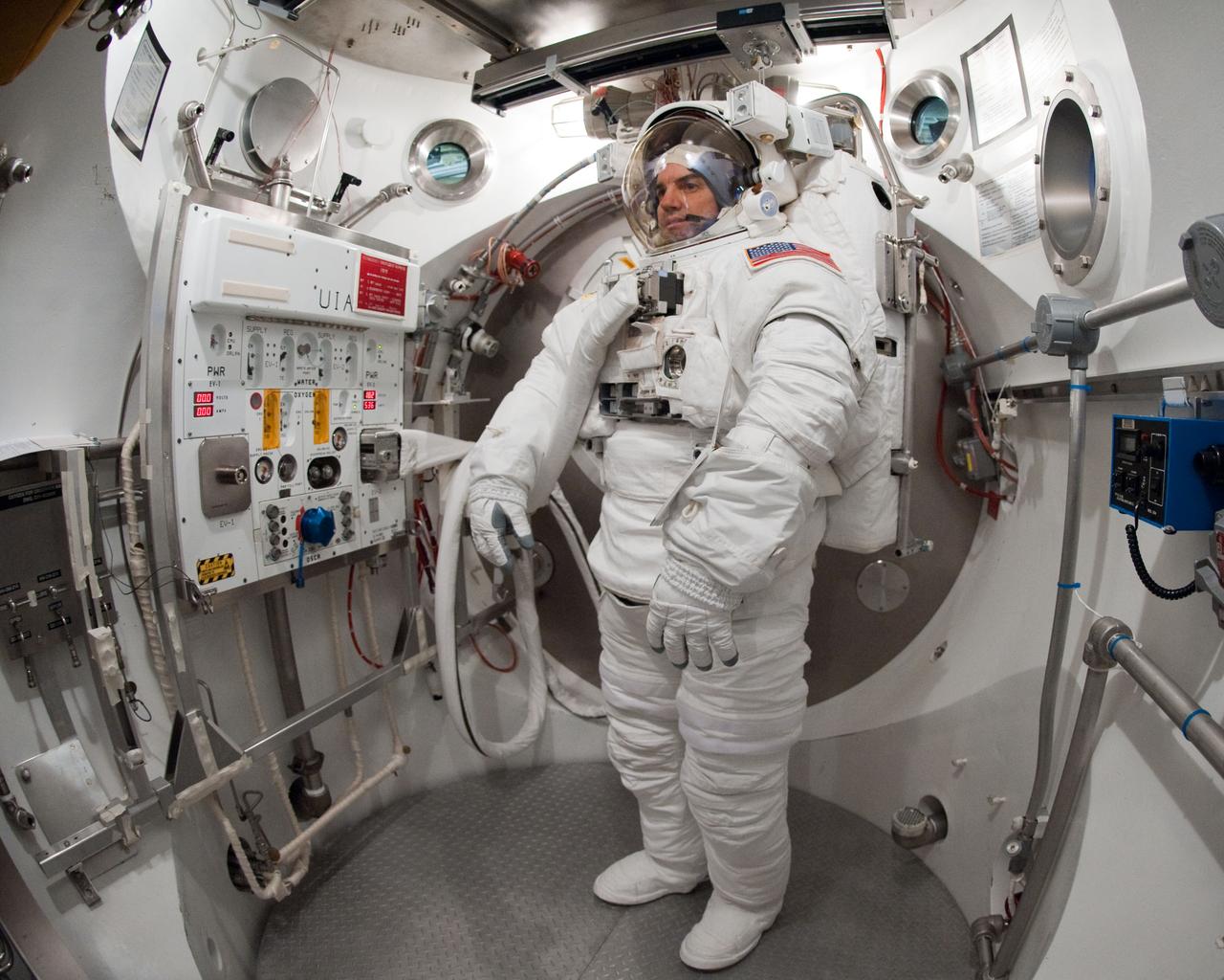 JSC2011-E-026880 (11 March 2011) --- NASA astronaut Rex Walheim, STS-135 mission specialist, participates in an Extravehicular Mobility Unit (EMU) spacesuit fit check in the Space Station Airlock Test Article (SSATA) in the Crew Systems Laboratory at NASA's Johnson Space Center. Photo credit: NASA or National Aeronautics and Space Administration