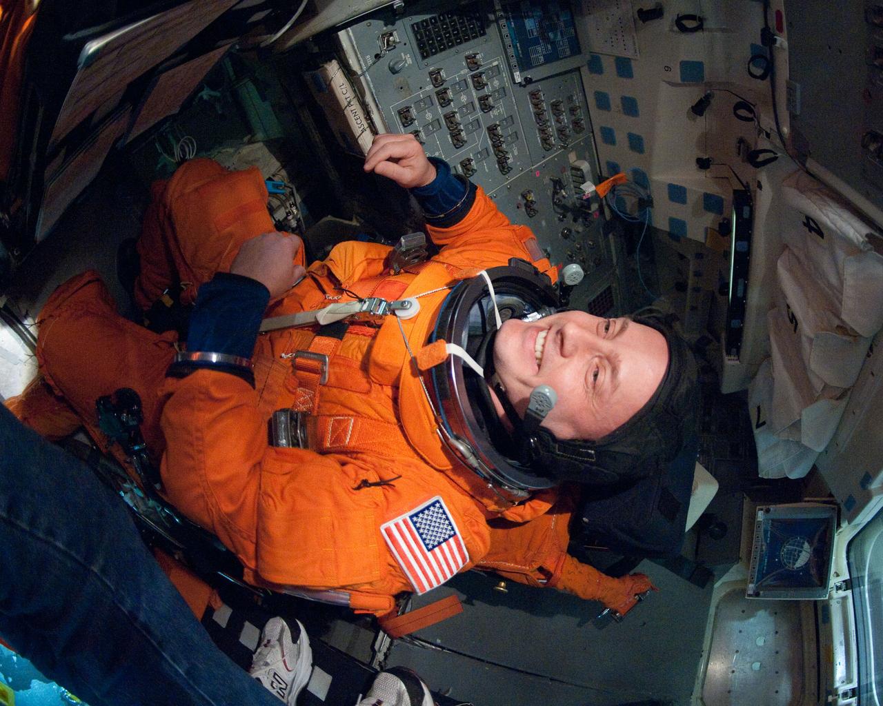 JSC2011-E-026942 (11 March 2011) --- NASA astronaut Michael Fincke, STS-134 mission specialist, attired in a training version of his shuttle launch and entry suit, participates in an ingress/egress training session in a shuttle mock-up in the Space Vehicle Mock-up Facility at NASA's Johnson Space Center. Photo credit: NASA or National Aeronautics and Space Administration