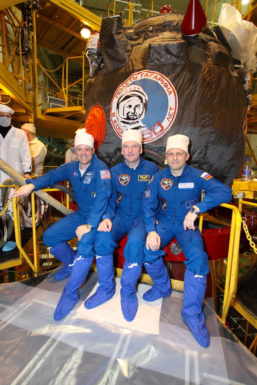 At the Baikonur Cosmodrome in Kazakhstan, Expedition 27 Flight Engineer Ron Garan of NASA (left), Soyuz Commander Alexander Samokutyaev (center) and Flight Engineer Andrey Borisenko pose for pictures outside their Soyuz TMA-21 spacecraft during a check of its systems March 22, 2011. The Soyuz, which has been dubbed “Gagarin” and which bears the likeness of cosmonaut Yuri Gagarin, the first human in space, is scheduled for launch on April 5 (April 4, U.S. time), just one week shy of the 50th anniversary of Gagarin’s historic journey into space from the same launch pad that the Expedition 27 crew will begin their mission rom. NASA/Victor Zelentsov