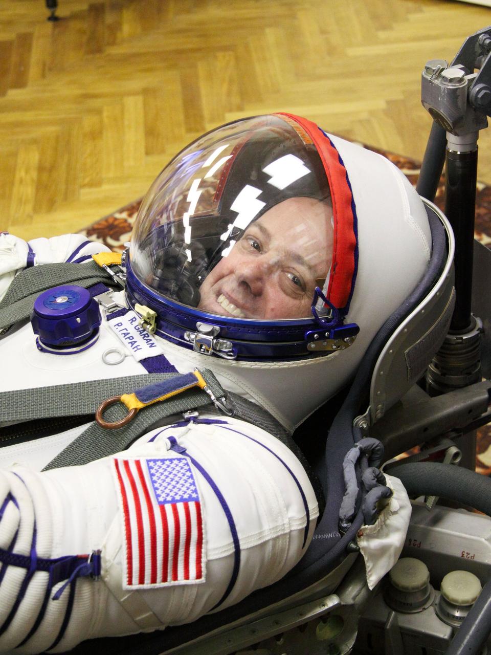 At the Baikonur Cosmodrome in Kazakhstan, Expedition 27 Flight Engineer Ron Garan of NASA flashes a smile during a leak check of his Russian Sokol launch and entry suit in the midst of a dress rehearsal of launch activities March 22, 2011. Garan, Soyuz Commander Alexander Samokutyaev and Flight Engineer Andrey Borisenko are scheduled to launch April 5 (April 4, U.S. time) in the Soyuz TMA-21 spacecraft that has been dubbed “Gagarin” in honor of the 50th anniversary of the launch of Yuri Gagarin as the first human in space from the same launch pad that the Expedition 27 will begin its journey from. NASA/Victor Zelentsov