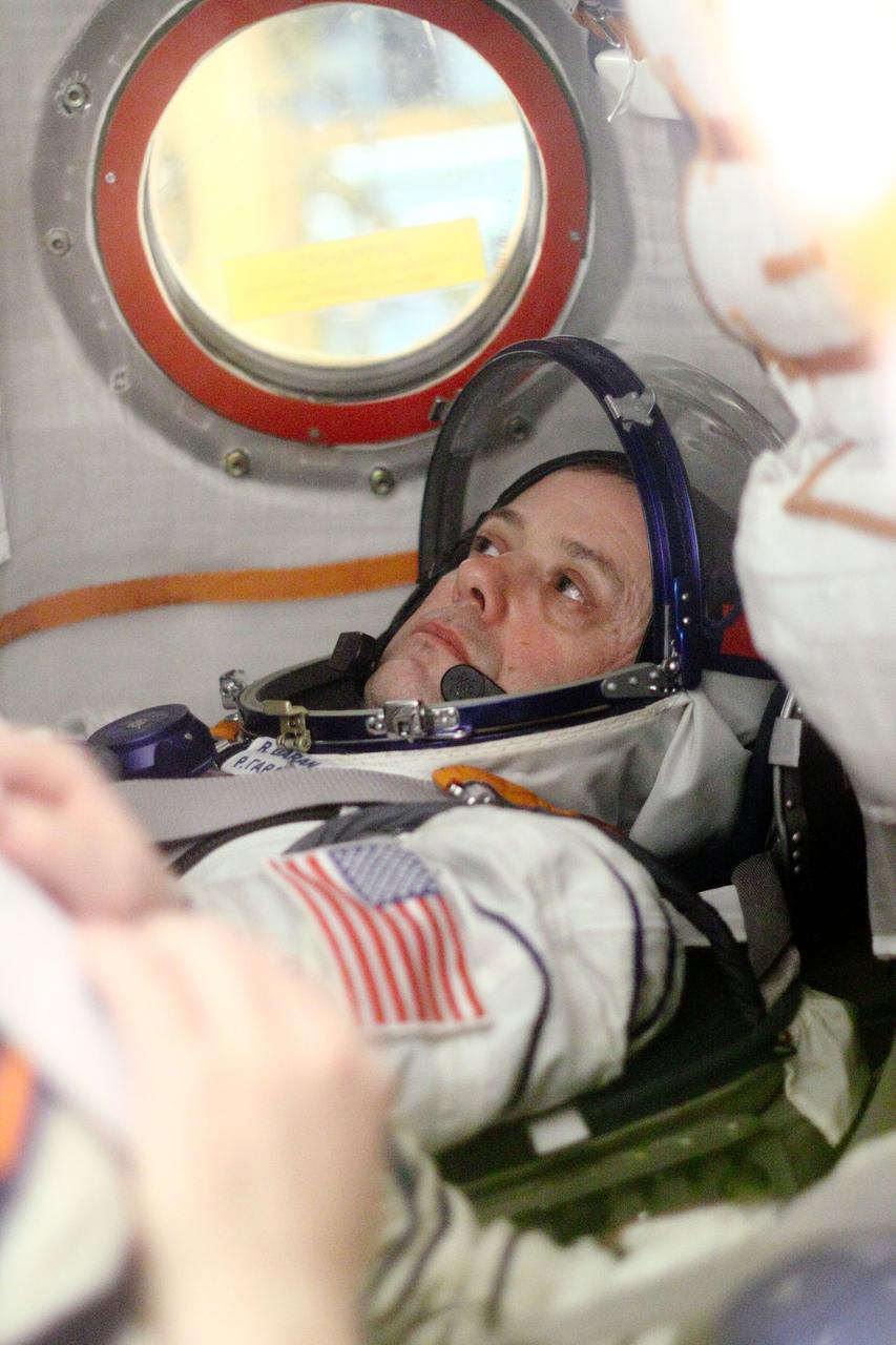 Seated in the right seat of the descent module of the Soyuz TMA-21 spacecraft, Expedition 27 Flight Engineer Ron Garan of NASA runs through a checklist of procedures during a dress rehearsal of launch activities at the Baikonur Cosmodrome in Kazakhstan March 22, 2011. Garan, Soyuz Commander Alexander Samokutyaev (center) and Flight Engineer Andrey Borisenko are scheduled to launch April 5 (April 4, U.S. time) in the Soyuz, which has been dubbed “Gagarin” and which bears the likeness of cosmonaut Yuri Gagarin, the first human in space. The launch will occur just one week shy of the 50th anniversary of Gagarin’s historic journey into space from the same launch pad that the Expedition 27 crew will begin their mission from. NASA/Victor Zelentsov