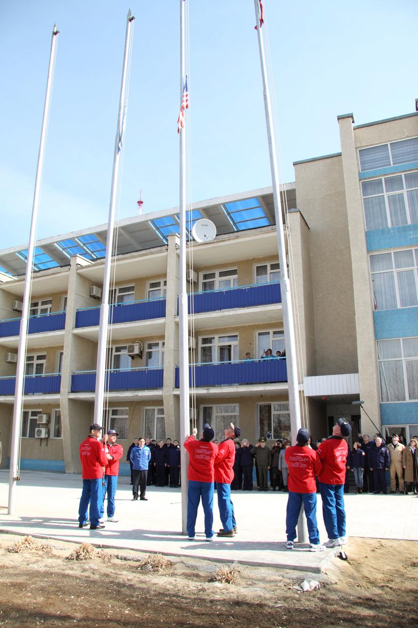 Outside their Cosmonaut Hotel crew quarters in Baikonur, Kazakhstan, the Expedition 27 prime and backup crewmembers conducted the ceremonial raising of the Russian, U.S. and Kazakh flags on March 23, 2011 as part of their traditional pre-launch activities. Seen from left to right are backup Russian crewmembers Anton Shkaplerov and Anatoly Ivanishin. prime NASA Flight Engineer Ron Garan (center) and his backup, Dan Burbank and prime Russian crewmembers Alexander Samokutyaev and Andrey Borisenko (right). Garan, Samokutyaev and Borisenko are scheduled to launch on April 5 (April 4, U.S. time) from the Baikonur Cosmodrome in Kazakhstan to the International Space Station on the Soyuz TMA-21 spacecraft that has been dubbed “Gagarin”, in honor of the 50th anniversary of the launch of Yuri Gagarin on April 12, 1961 to become the first human to fly in space. Credit: NASA/Victor Zelentsov