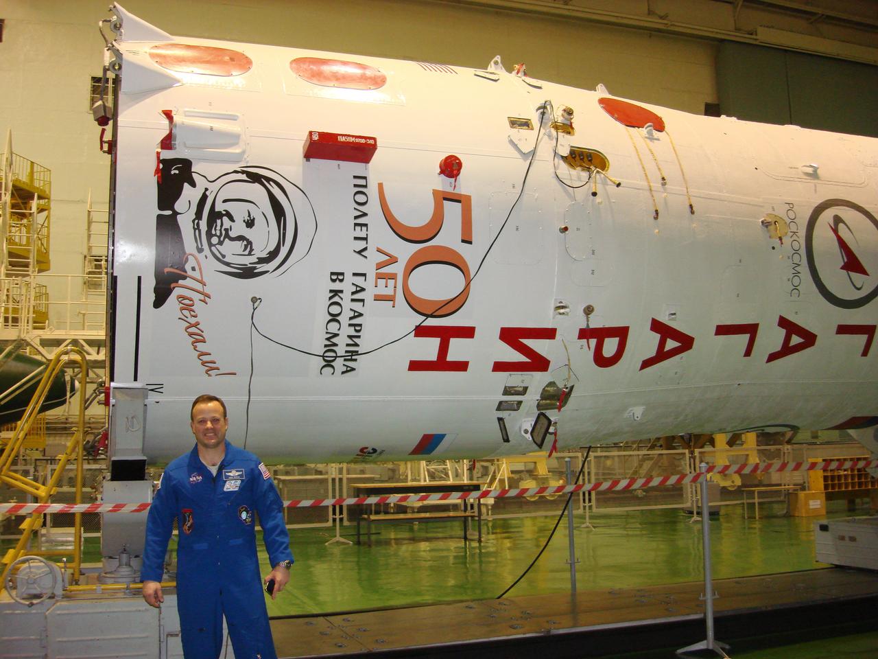At the Baikonur Cosmodrome in Kazakhstan, Expedition 27 Flight Engineer Ron Garan of NASA stands in front of the Soyuz booster March 22, 2011 that will carry him, Soyuz TMA-21 Commander Alexander Samokutyaev and Flight Engineer Andrey Borisenko to the International Space Station. Their launch is scheduled for April 5 (April 4, U.S. time). The Soyuz booster bears the name and likeness of Yuri Gagarin, the first human to fly in space and the Soyuz TMA-21 spacecraft has been dubbed “Gagarin”, all in honor of the 50th anniversary of Gagarin’s historic flight on April 12, 1961. NASA/Dr. Paul Stoner