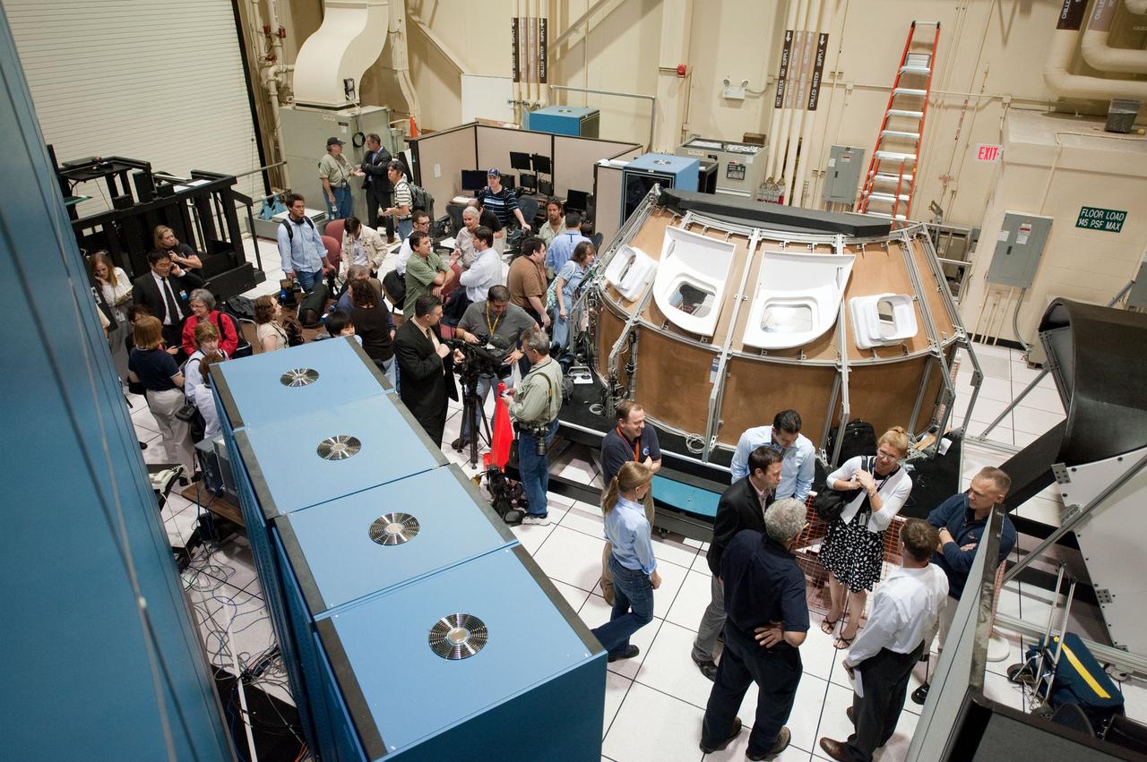 JSC2011-E-028127 (23 March 2011) --- NASA astronauts Chris Ferguson, STS-135 commander; Doug Hurley, pilot; and Sandy Magnus, mission specialist; along with news media representatives and NASA personnel are pictured during an STS-135 media day event in the Avionics Systems Laboratory at NASA's Johnson Space Center. Photo credit: NASA or National Aeronautics and Space Administration