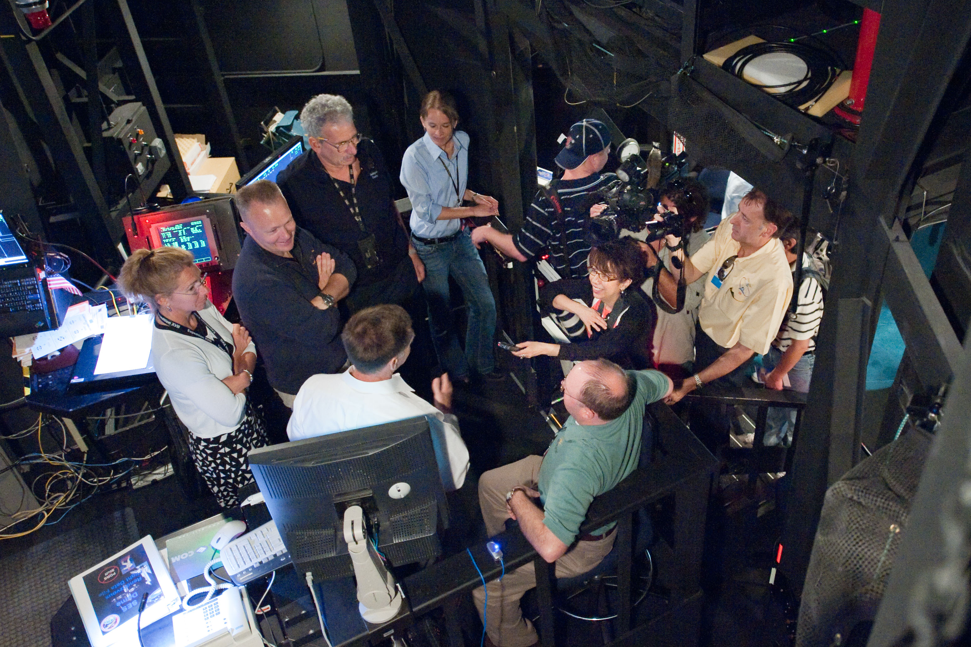 JSC2011-E-028142 (23 March 2011) --- NASA astronauts Chris Ferguson (left foreground), STS-135 commander; Doug Hurley (left background), pilot; and Sandy Magnus (left), mission specialist, speak with news media representatives during an exercise in the systems engineering simulator in the Avionics Systems Laboratory at NASA's Johnson Space Center. The facility includes moving scenes of full-sized International Space Station components over a simulated Earth. Photo credit: NASA or National Aeronautics and Space Administration