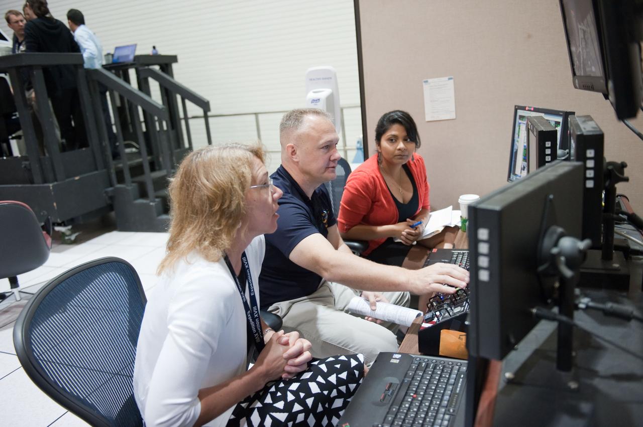 JSC2011-E-028150 (23 March 2011) --- NASA astronauts Doug Hurley, STS-135 pilot; and Sandy Magnus (foreground), mission specialist, participate in an exercise in the systems engineering simulator in the Avionics Systems Laboratory at NASA's Johnson Space Center. Photo credit: NASA or National Aeronautics and Space Administration