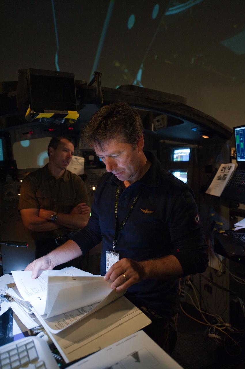 JSC2011-E-028156 (23 March 2011) --- European Space Agency astronaut Roberto Vittori (foreground) and NASA astronaut Andrew Feustel, both STS-134 mission specialists, participate in an exercise in the systems engineering simulator in the Avionics Systems Laboratory at NASA's Johnson Space Center. The facility includes moving scenes of full-sized International Space Station components over a simulated Earth. Photo credit: NASA or National Aeronautics and Space Administration