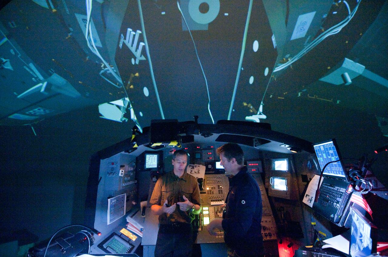 JSC2011-E-028173 (23 March 2011) --- European Space Agency astronaut Roberto Vittori (right) and NASA astronaut Andrew Feustel, both STS-134 mission specialists, participate in an exercise in the systems engineering simulator in the Avionics Systems Laboratory at NASA's Johnson Space Center. The facility includes moving scenes of full-sized International Space Station components over a simulated Earth. Photo credit: NASA or National Aeronautics and Space Administration