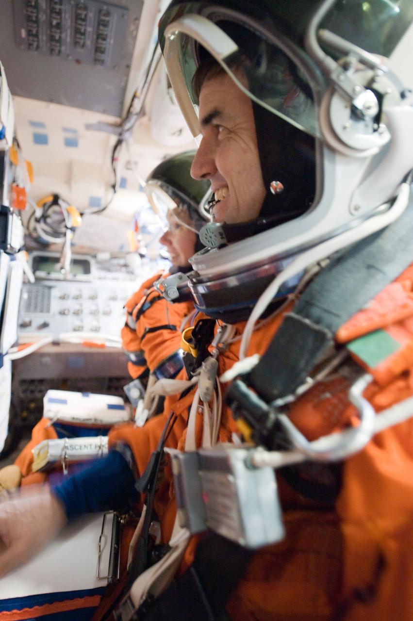 JSC2011-E-028482 (24 March 2011) --- NASA astronauts Rex Walheim and Sandy Magnus, both STS-135 mission specialists, attired in training versions of their shuttle launch and entry suits, participate in a training session in the Full Fuselage Trainer (FFT) in the Space Vehicle Mock-up Facility at NASA's Johnson Space Center. Photo credit: NASA or National Aeronautics and Space Administration