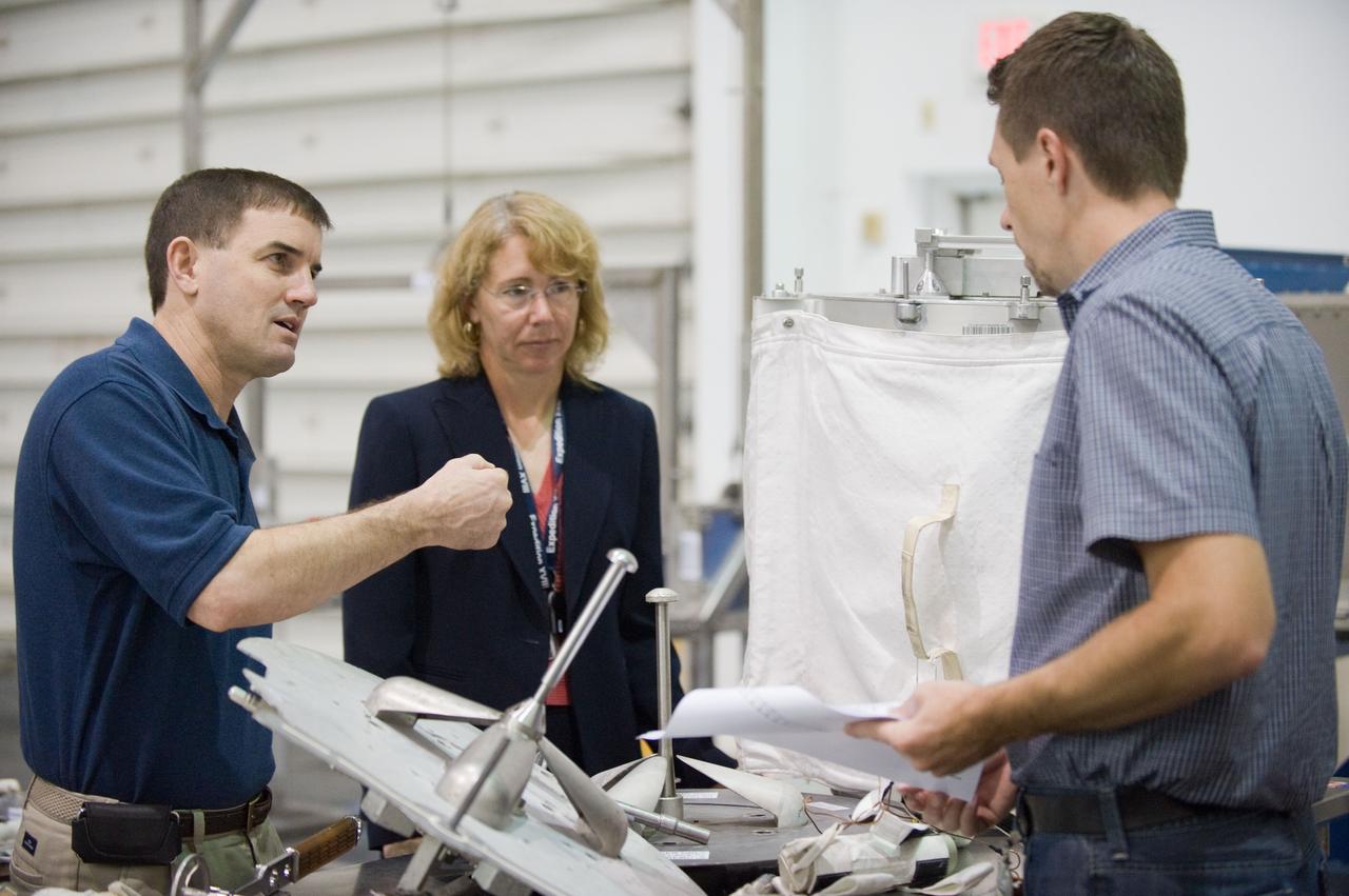 JSC2011-E-029013 (21 March 2011) --- NASA astronauts Rex Walheim (left) and Sandy Magnus, both STS-135 mission specialists, participate in an extravehicular activity (EVA) hardware training session in the Neutral Buoyancy Laboratory (NBL) near NASA's Johnson Space Center. EVA instructor Art Thomason assisted Walheim and Magnus. STS-135 is planned to be the final mission of the space shuttle program. Photo credit: NASA or National Aeronautics and Space Administration