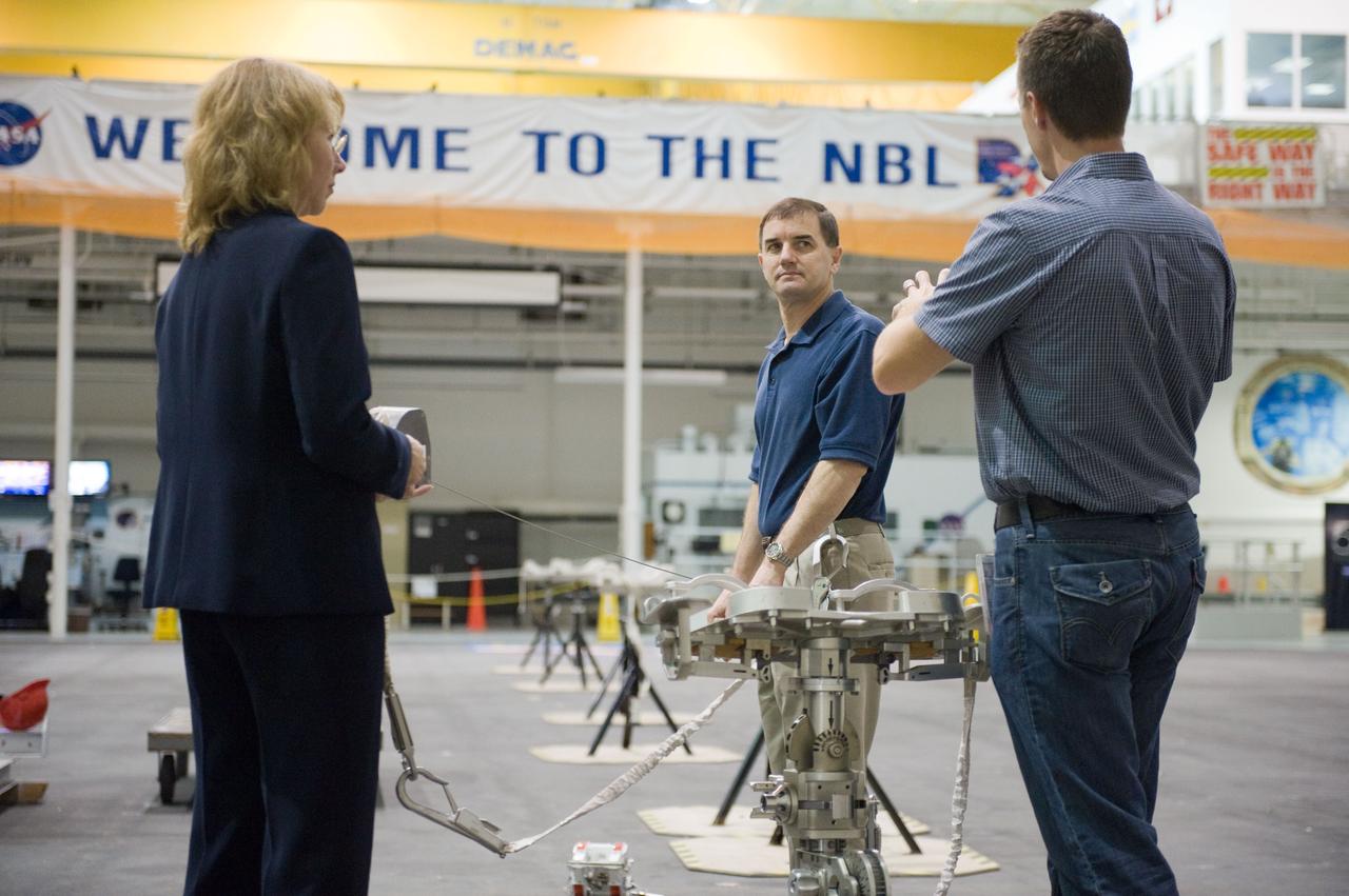 JSC2011-E-029017 (21 March 2011) --- NASA astronauts Rex Walheim (center) and Sandy Magnus, both STS-135 mission specialists, participate in an extravehicular activity (EVA) hardware training session in the Neutral Buoyancy Laboratory (NBL) near NASA's Johnson Space Center. EVA instructor Art Thomason assisted Walheim and Magnus. STS-135 is planned to be the final mission of the space shuttle program. Photo credit: NASA or National Aeronautics and Space Administration