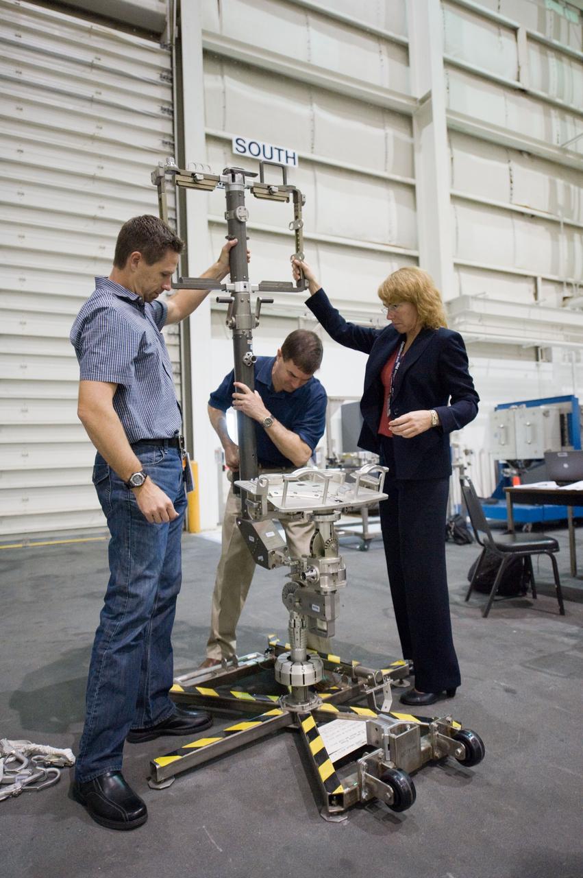 JSC2011-E-029027 (21 March 2011) --- NASA astronauts Rex Walheim (center) and Sandy Magnus, both STS-135 mission specialists, participate in an extravehicular activity (EVA) hardware training session in the Neutral Buoyancy Laboratory (NBL) near NASA's Johnson Space Center. EVA instructor Art Thomason assisted Walheim and Magnus. STS-135 is planned to be the final mission of the space shuttle program. Photo credit: NASA or National Aeronautics and Space Administration