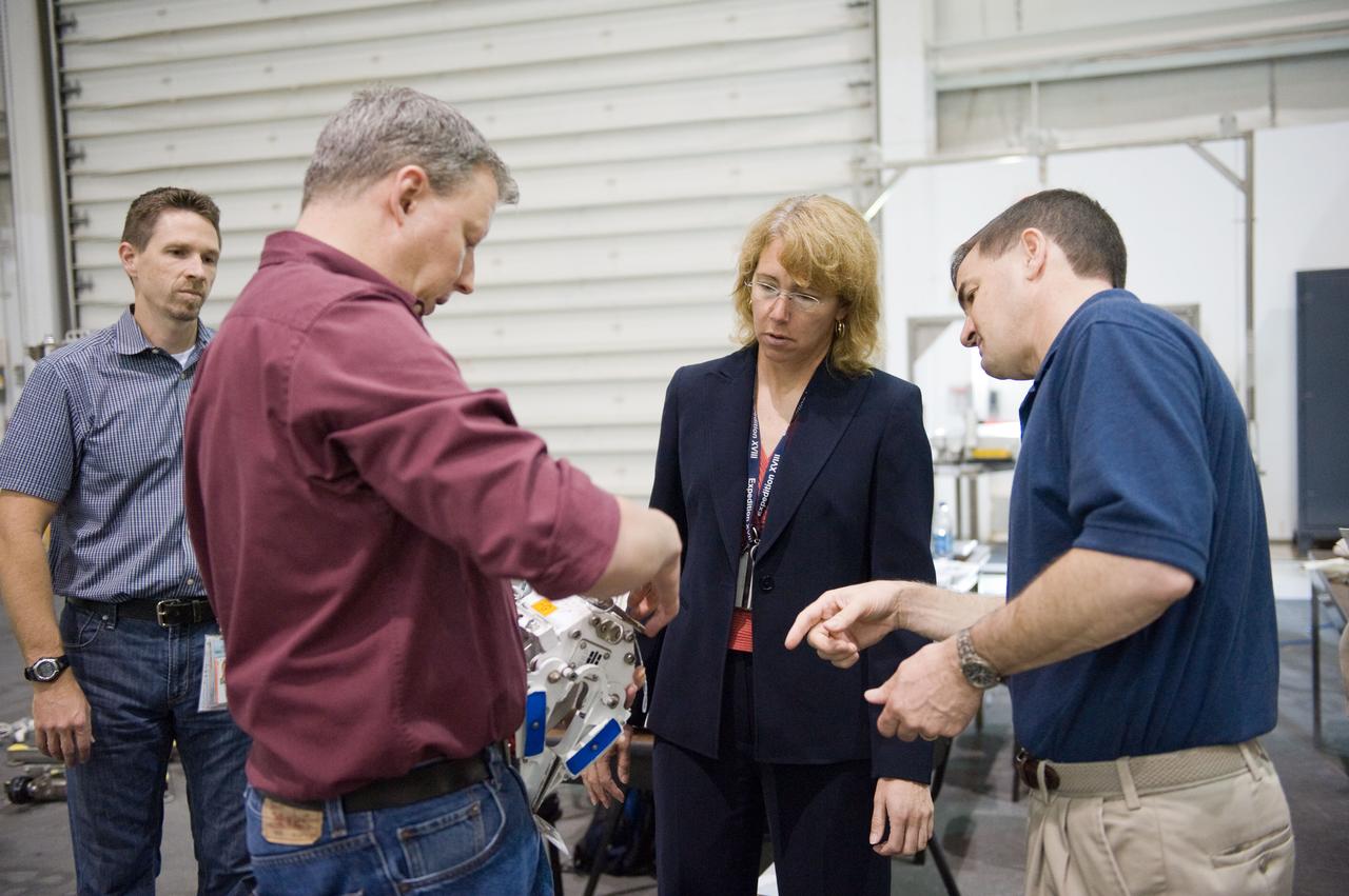 JSC2011-E-029041 (21 March 2011) --- NASA astronauts Rex Walheim (right) and Sandy Magnus, both STS-135 mission specialists, participate in an extravehicular activity (EVA) hardware training session in the Neutral Buoyancy Laboratory (NBL) near NASA's Johnson Space Center. EVA instructors John Ray (left foreground) and Art Thomason assisted Walheim and Magnus. STS-135 is planned to be the final mission of the space shuttle program. Photo credit: NASA or National Aeronautics and Space Administration